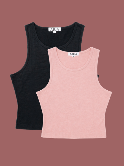 Black and pink tank tops with 'AIUA' branding on a brown background