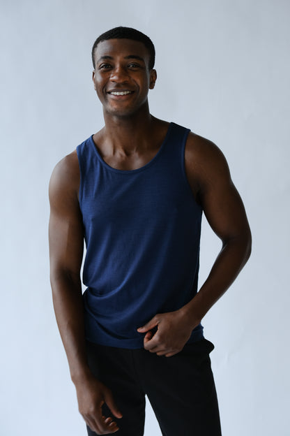 Man wearing a blue tank top against a plain background