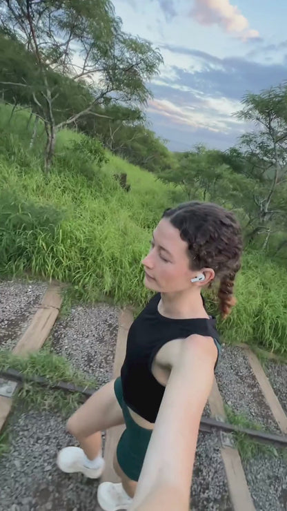 Woman hiking along rail tracks